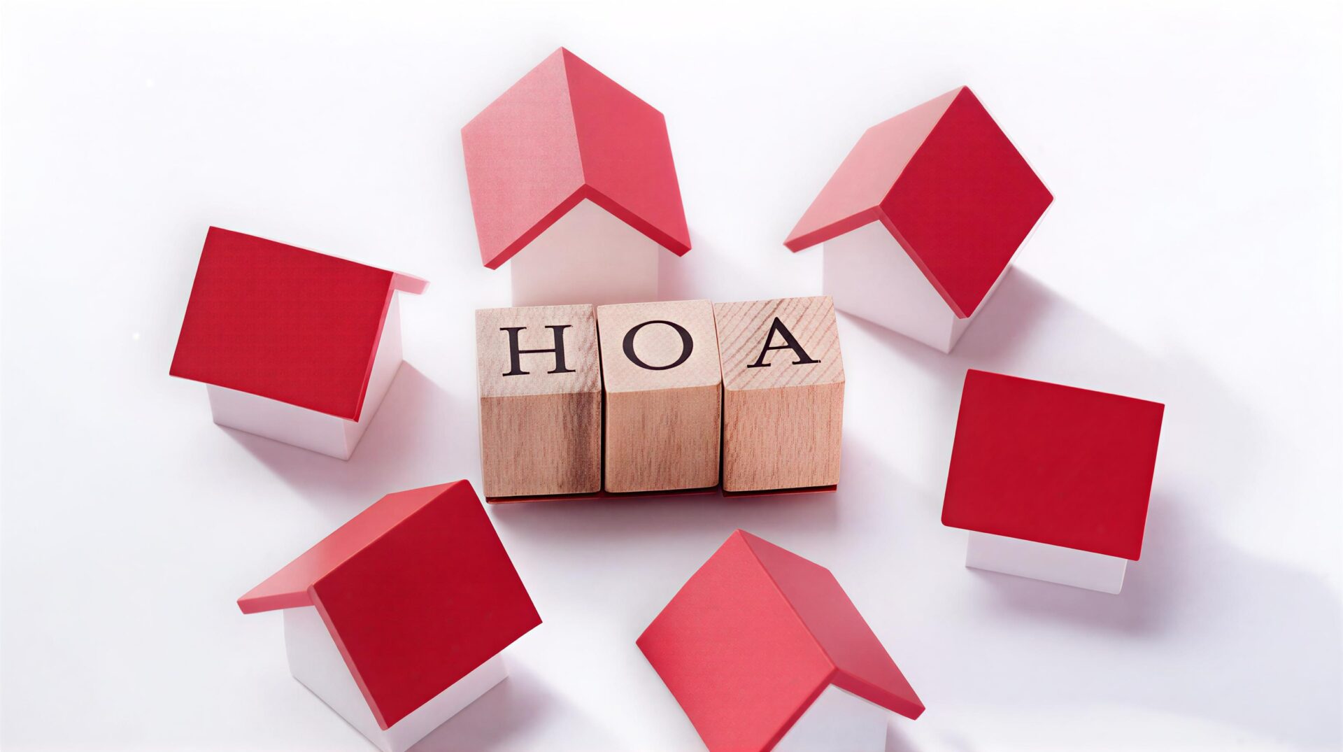 Miniature houses surrounding blocks spelling HOA