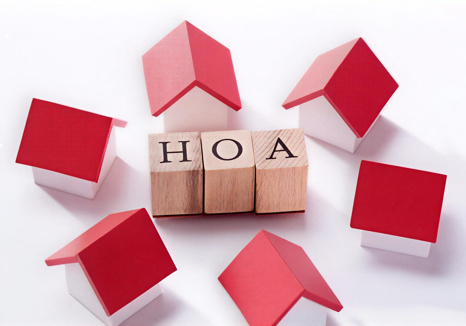 Miniature houses surrounding blocks spelling HOA
