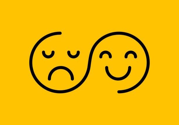 Yin-yang happy and sad faces on yellow