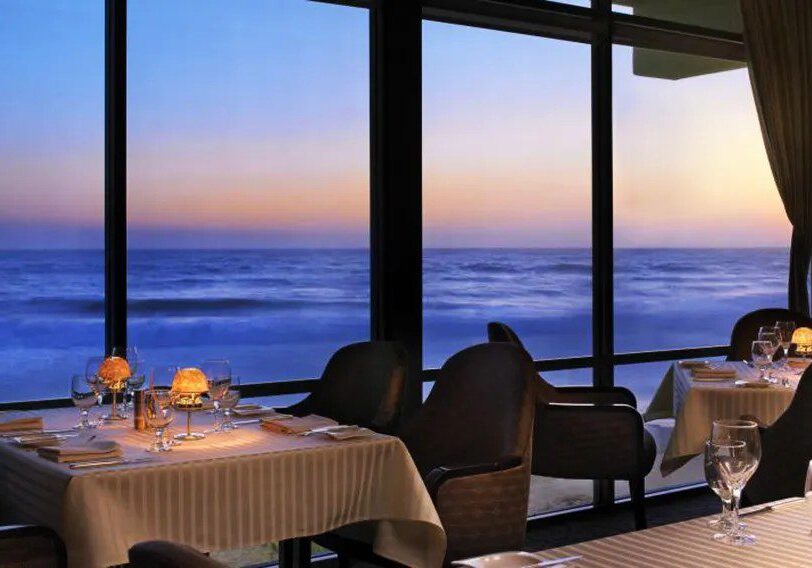 Elegant seaside restaurant with sunset ocean view